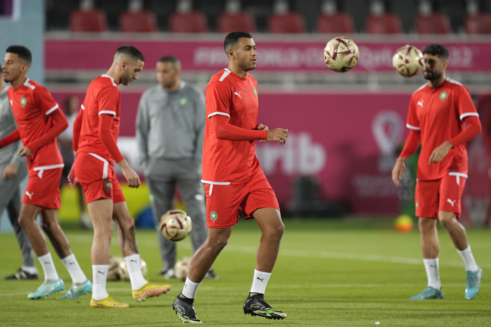 Morocco's Walid Cheddira, center, and teammates practice during a training session at the Duhail Stadium in Doha, Qatar, Tuesday, Dec. 13, 2022. Morocco will face France in a World Cup semifinal soccer match on Dec. 14. (AP Photo/Andre Penner)