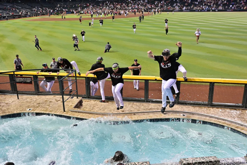 The Diamondbacks players celebrate their sweep over the Dodgers by jumping into a pool at Chase Field.