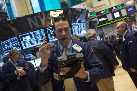 Traders work on the floor of the New York Stock Exchange May 12, 2014. REUTERS/Brendan McDermid