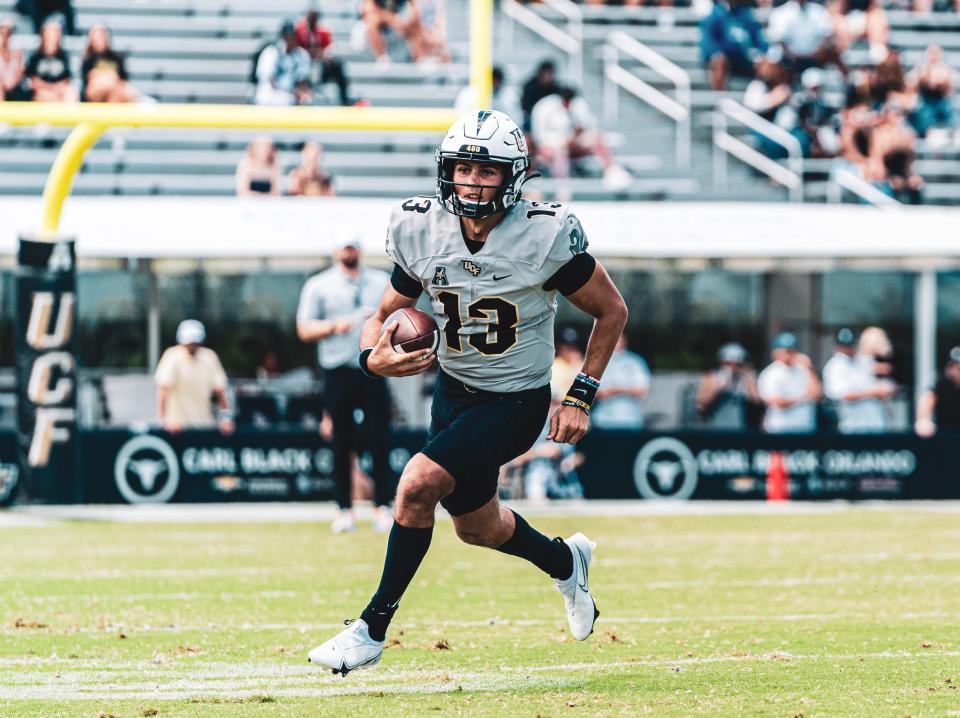 Mikey Keene scrambles for yardage during UCF's spring game, Saturday, April 16, 2022.