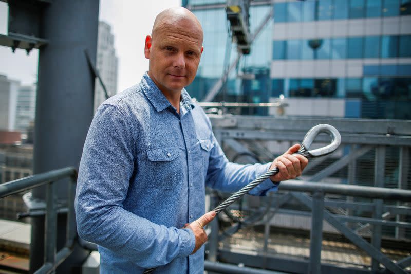 FILE PHOTO: Aerialist Wallenda holds a sample of a wire while he speaks with media as he prepares for a highwire walk over Times Square in New York