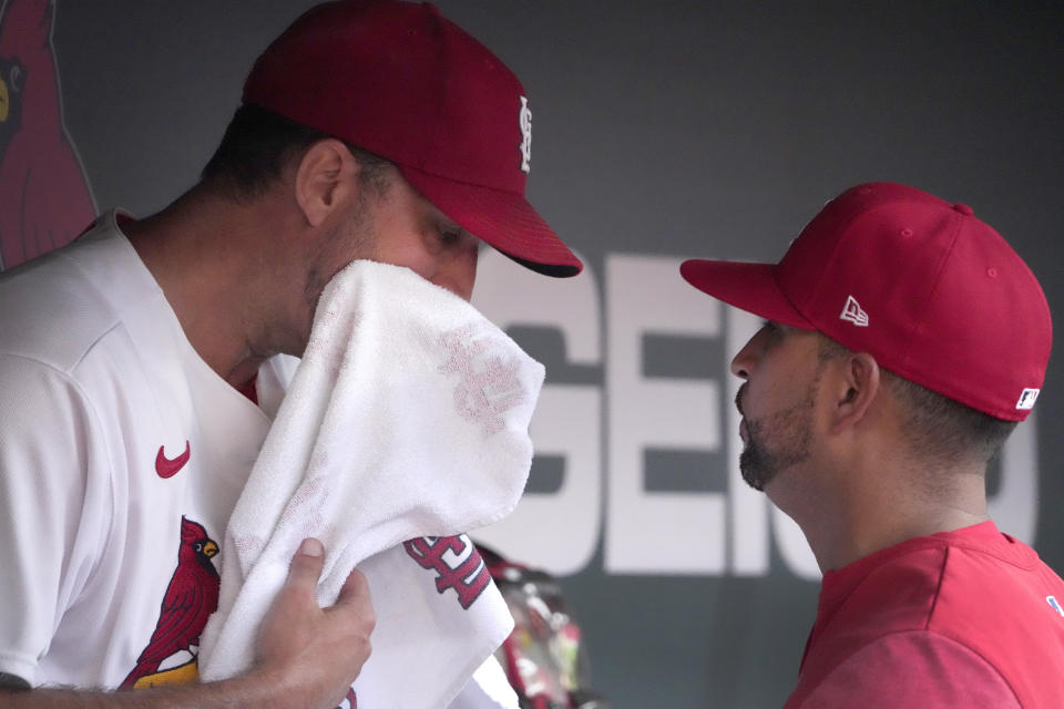 St. Louis Cardinals starting pitcher Adam Wainwright, left, talks with manager Oliver Marmol after being removed during the second inning of a baseball game against the Houston Astros Thursday, June 29, 2023, in St. Louis. (AP Photo/Jeff Roberson)