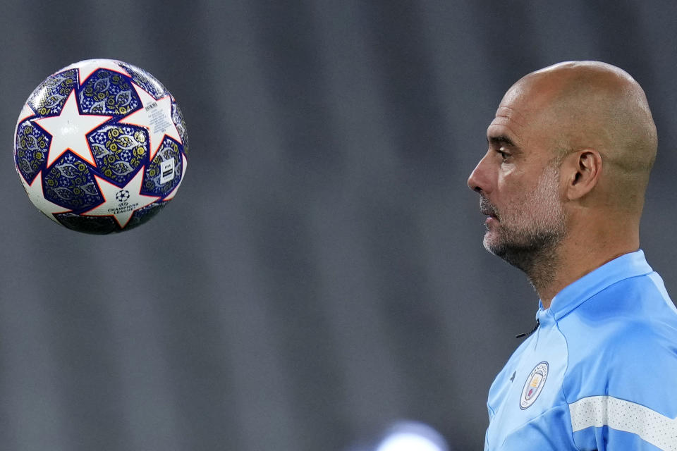 Manchester City's head coach Pep Guardiola eyes the ball during a training session at the Ataturk Olympic Stadium in Istanbul, Turkey, Friday, June 9, 2023. Manchester City and Inter Milan are making their final preparations ahead of their clash in the Champions League final on Saturday night. (AP Photo/Manu Fernandez)