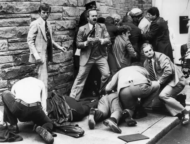 PHOTO: Secret Service agents, police officers, and bystanders take action seconds after shots were fired at President Reagan and his retinue by John Hinckley, Jr. (Bettmann via Getty Images)