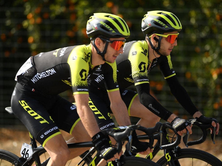 Adam and Simon Yates riding bikes next to each other