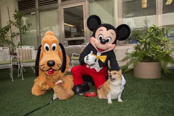 Pluto and Mickey Mouse pose with California Governor Brown's dogs.