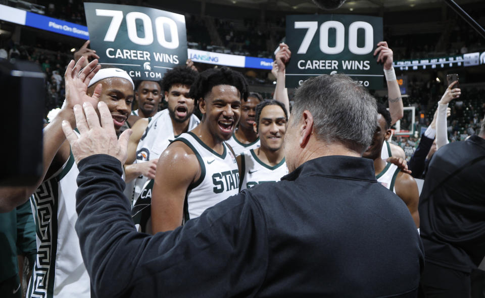 Michigan State coach Tom Izzo, foreground, is greeted by his players after his 700th career win following an NCAA college basketball game against Michigan, Tuesday, Jan. 30, 2024, in East Lansing, Mich. Michigan State won 81-62. (AP Photo/Al Goldis)