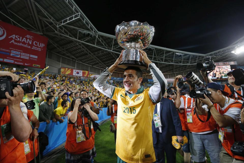 Australia's Cahill holds the Asian Cup trophy after they beat South Korea to win the tournament in Sydney