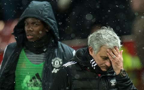 Manchester United's Portuguese manager Jose Mourinho (R) and French midfielder Paul Pogba leave after the English FA Cup quarter-final football match between Manchester United and Brighton