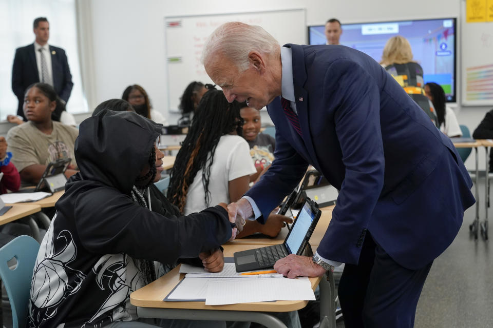 President Joe Biden shakes hands with a student at Eliot-Hine Middle School on Monday, Aug. 28, 2023, in Washington. Biden visited the school, located east of the U.S. Capitol, to mark the District of Columbia's first day of school for the 2023-24 year. (AP Photo/Manuel Balce Ceneta)