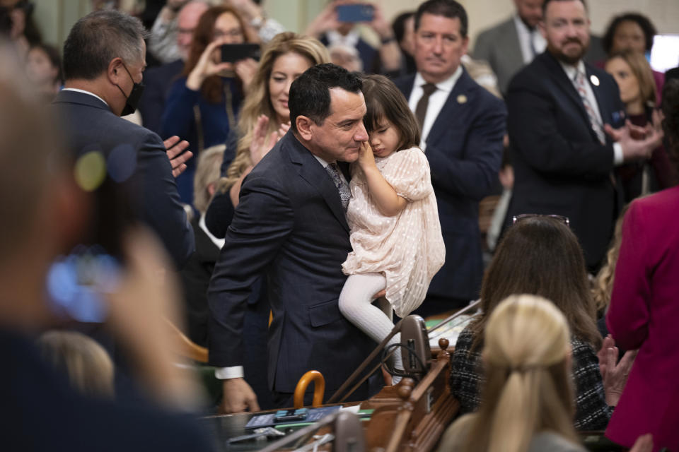 FILE – Assemblymember Anthony Rendon walks with his daughter, Vienna, before being sworn in as Speaker of the Assembly on Dec. 5, 2022. Rendon will step down as speaker on Friday, June 30, 2023, giving way to Assemblymember Robert Rivas. Rendon has been in office since 2016, making him the second-longest serving speaker in state history. (AP Photo/José Luis Villegas, Pool, File)