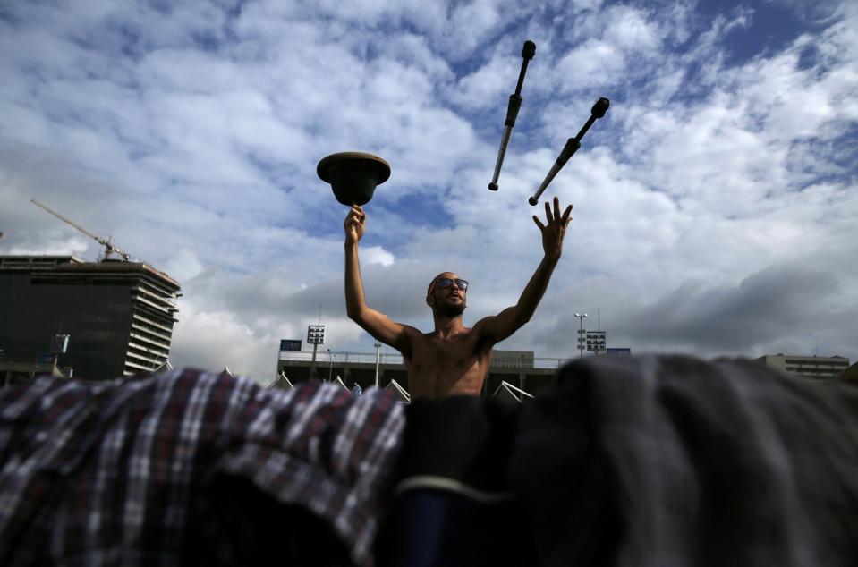 An Argentinian fan juggles next to his tent as he passes time amongst others before Sunday's World Cup final between Argentina and Germany at the Terreirao do Samba in Rio de Janeiro