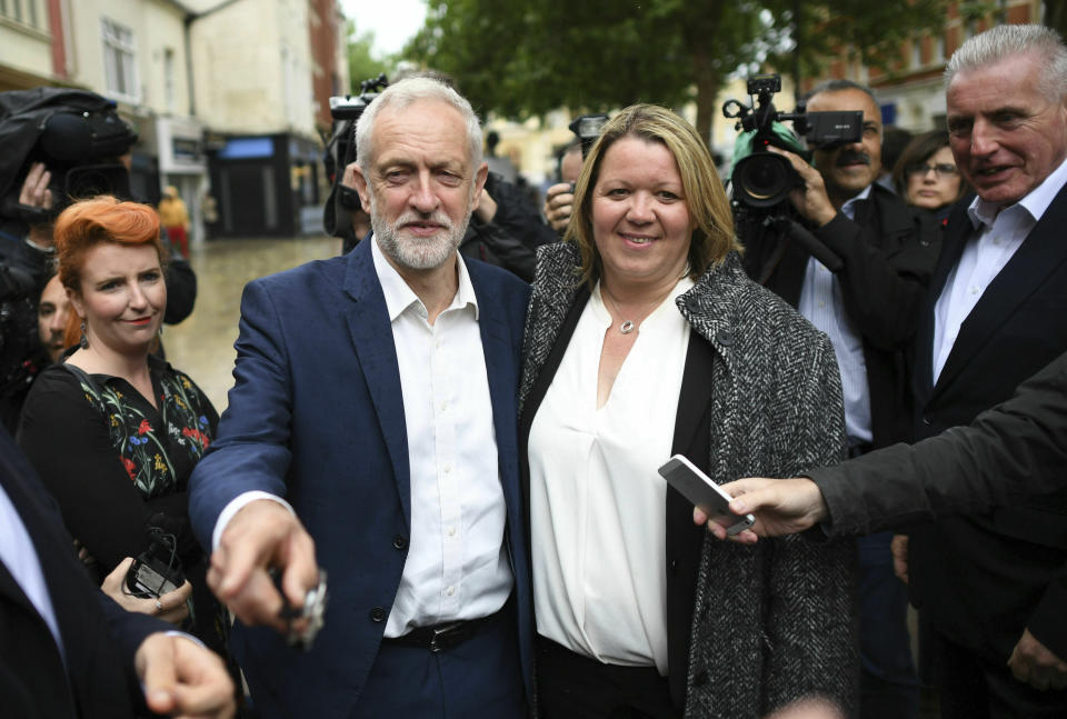 Labour Party leader Jeremy Corbyn , centre left, celebrates with newly elected Labour MP Lisa Forbes at Cathedral Square, following her victory in the Peterborough by-election, in Peterborough, England, Friday June 7, 2019. (Stefan Rousseau/PAvia AP)