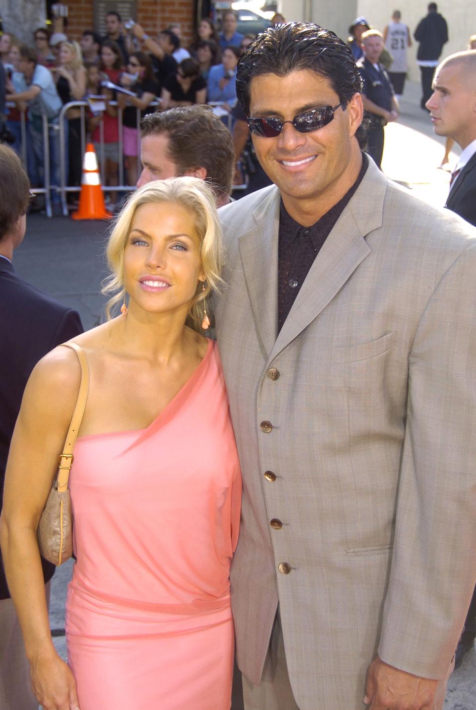 Jose Canseco with then-wife Jessica at a premiere in 2004. (Photo: Jeff Kravitz/FilmMagic)