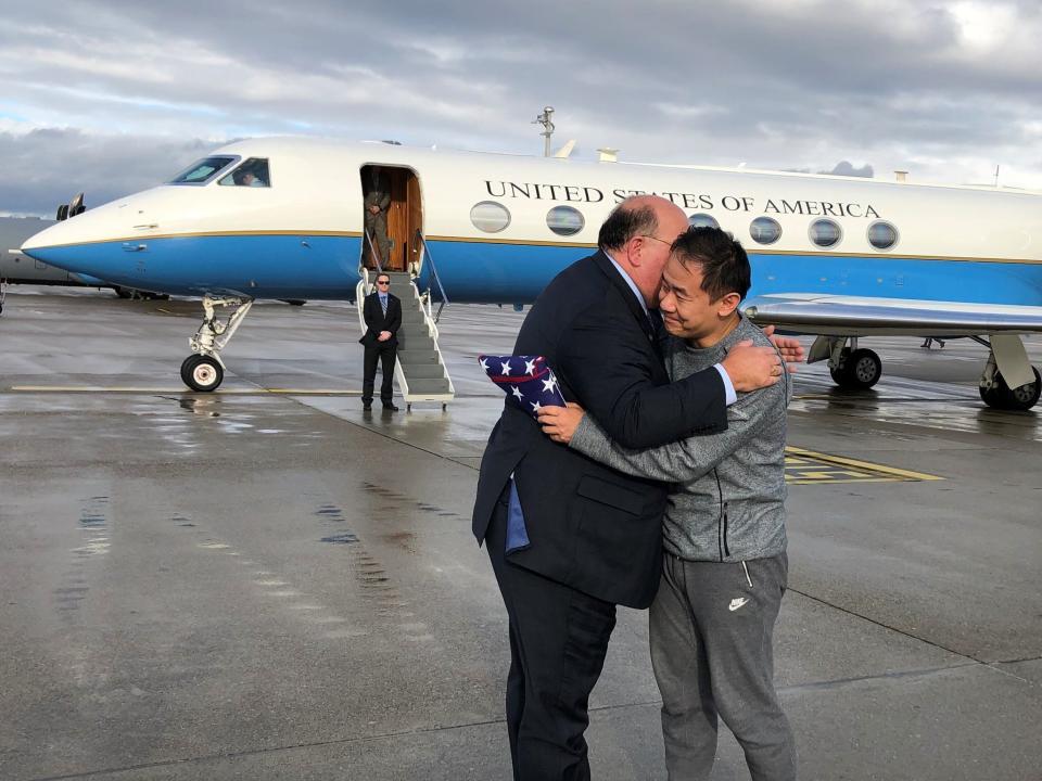 This photo provided by U.S. Embassy Switzerland, Edward McMullen greets Xiyue Wang in Zurich, Switzerland on Saturday, Dec. 7, 2019. In a trade conducted in Zurich, Iranian officials handed over Chinese-American graduate student Xiyue Wang, detained in Tehran since 2016, for scientist Massoud Soleimani, who had faced a federal trial in Georgia. (U.S. Embassy Switzerland via AP)