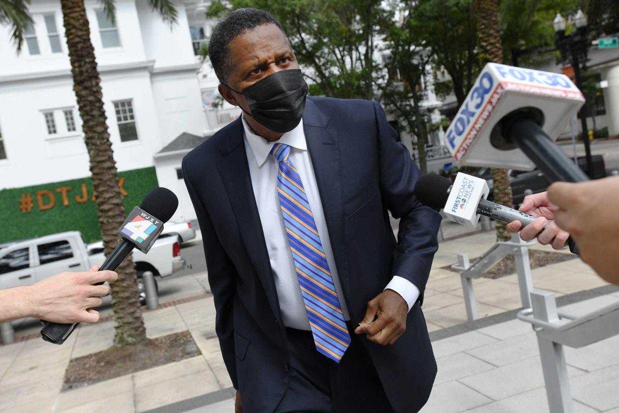 Former Jacksonville City Council member Reggie Brown faced a line of cameras and reporters when he reached Jacksonville's federal courthouse for sentencing on a fraud case in October 2020.