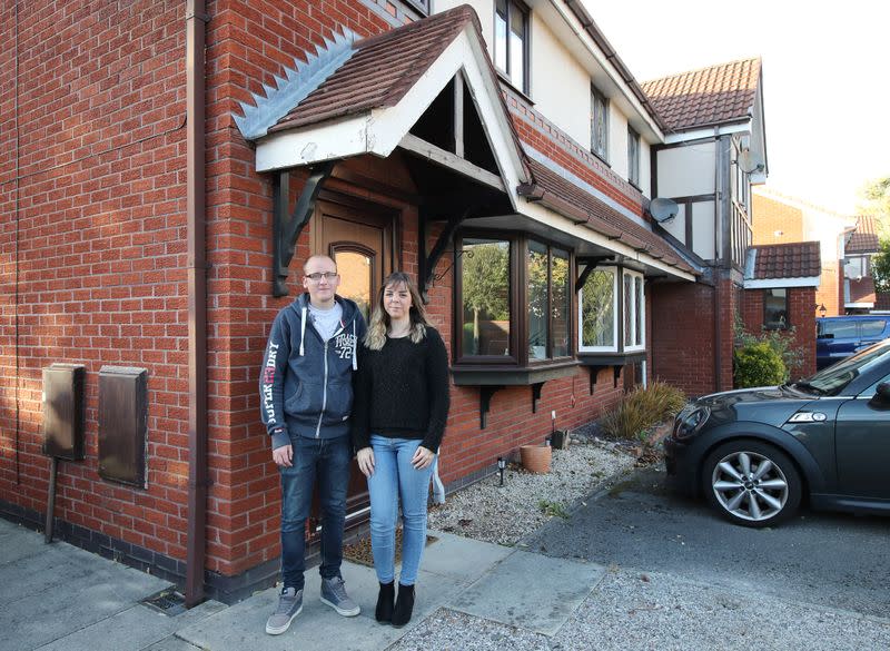 Claire Tomlinson and her partner Ricky Collier pose for a portrait in Sandbach