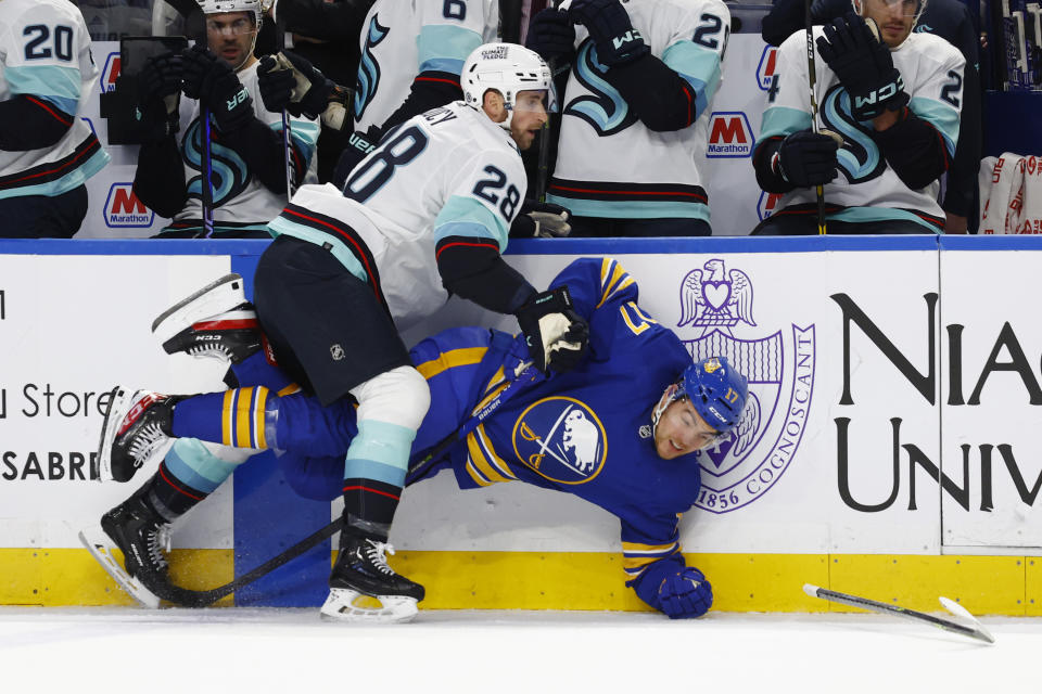 Buffalo Sabres center Tyson Jost (17) is checked by Seattle Kraken defenseman Carson Soucy (28) during the first period of an NHL hockey game, Tuesday, Jan. 10, 2023, in Buffalo, N.Y. (AP Photo/Jeffrey T. Barnes)