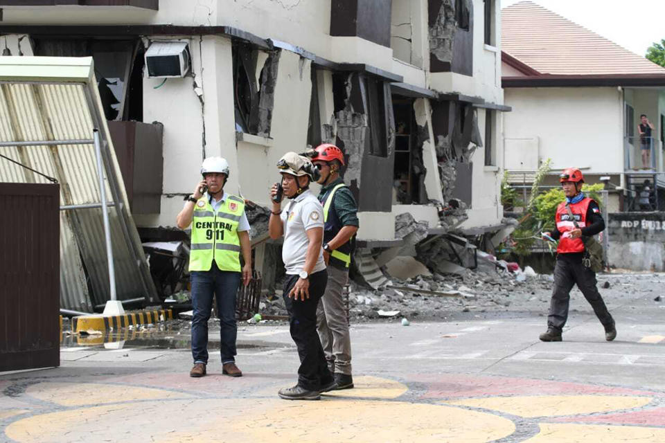 Rescue workers assess the damage in a residential condominium building that partially collapsed after a strong earthquake in Davao City, Philippines, Thursday, Oct. 31 2019. The third strong earthquake this month jolted the southern Philippines on Thursday morning, further damaging structures already weakened by the earlier shaking. (AP Photo)