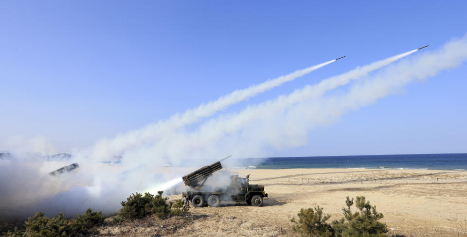 South Korean Army's 130mm multiple rocket launchers fire live rounds during an exercise against possible attacks from North Korea in Goseong, South Korea, Monday, March 3, 2014. North Korea fired two additional suspected short-range missiles into the sea Monday amid ongoing military exercises between Seoul and Washington, which the North calls a preparation for an attack, South Korean officials said. (AP Photo/Yonhap, Lee Jong-gun) KOREA OUT