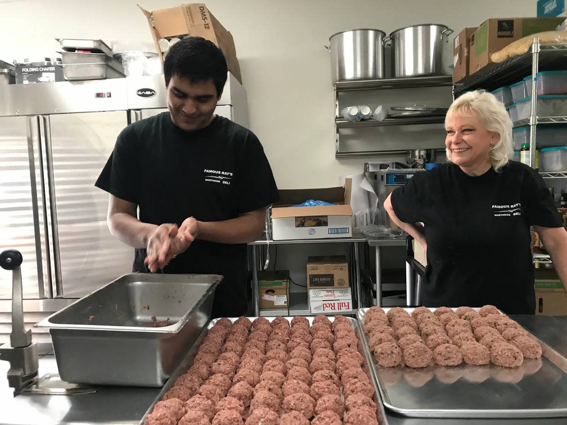 Owner Debbie Harkness, right, laughs with an employee making meatballs by hand at newly opened Famous Ray’s Northside Deli near Fresno State.