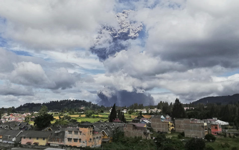 Mount Sinabung spews volcanic materials into the air as it erupts, in Karo, North Sumatra, Indonesia, Monday, Aug. 10, 2020. The rumbling volcano erupted Monday, sending a column of volcanic materials a few thousands meters into the sky. Sinabung is among more than 120 active volcanoes in Indonesia, which is prone to seismic upheaval due to its location on the Pacific "Ring of Fire," an arc of volcanoes and fault lines encircling the Pacific Basin. (AP Photo/Sugeng Nuryono)