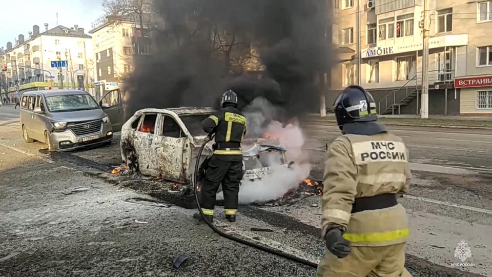 FILE - In this photo taken from video released by Russia Emergency Situations Ministry’s Telegram channel on Saturday, Dec. 30, 2023, firefighters respond to burning cars after shelling in Belgorod, Russia. A missile attack on the city near the Ukrainian border that day killed 25 and injured 109. Such attacks are dealing a blow to President Vladimir Putin’s attempts to reassure Russians that life in the country is largely untouched by the nearly 2-year-old conflict. (Russia Emergency Situations Ministry Telegram channel via AP, File)