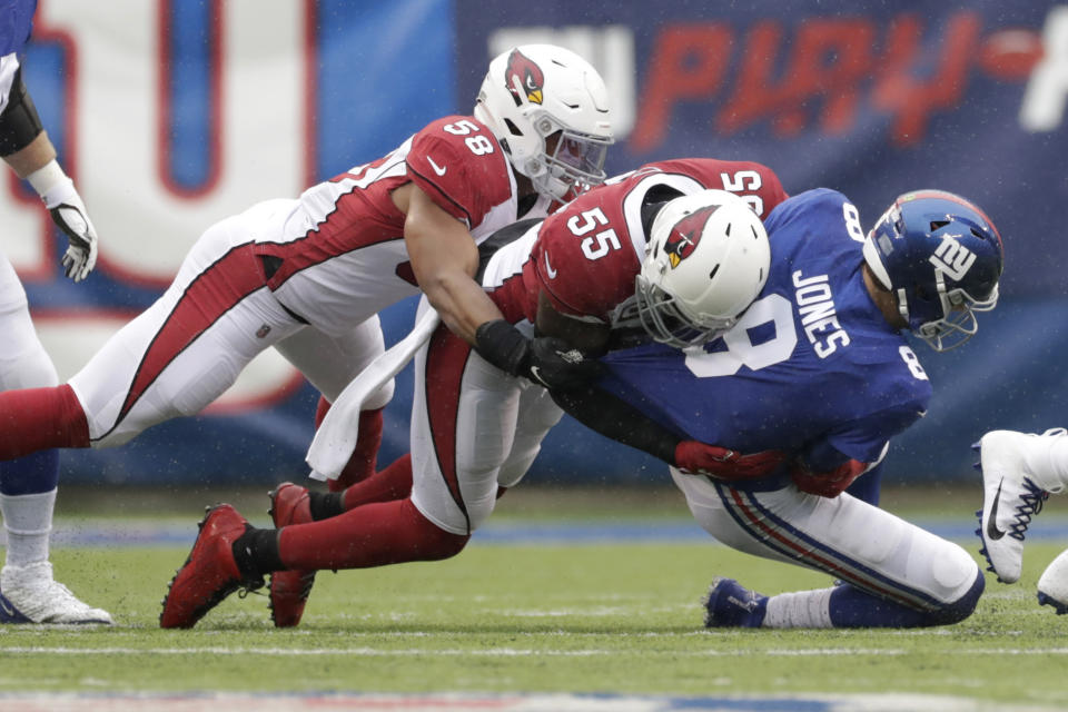 New York Giants quarterback Daniel Jones, right, is sacked by Arizona Cardinals' Jordan Hicks, left, and Chandler Jones (55) during the first half of an NFL football game, Sunday, Oct. 20, 2019, in East Rutherford, N.J. (AP Photo/Adam Hunger)