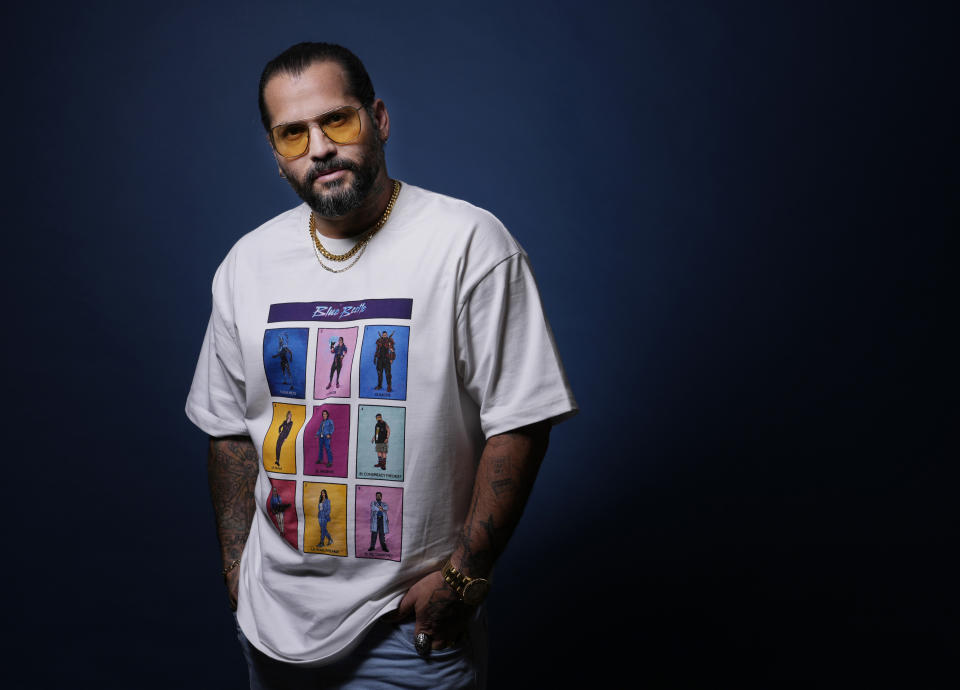 Angel Manuel Soto, director of "Blue Beetle," wears a shirt displaying the film's cast as he poses for a portrait, Friday, Aug. 4, 2023, at the London Hotel in West Hollywood, Calif. The "Blue Beetle" cast members could not promote the film as per SAG-AFTRA guidelines during the actors' strike.(AP Photo/Chris Pizzello)