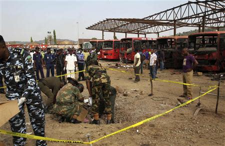 Bomb experts gather evidence in a crater that was caused by a bomb blast explosion at Nyanyan, Abuja April 14, 2014. REUTERS/Afolabi Sotunde