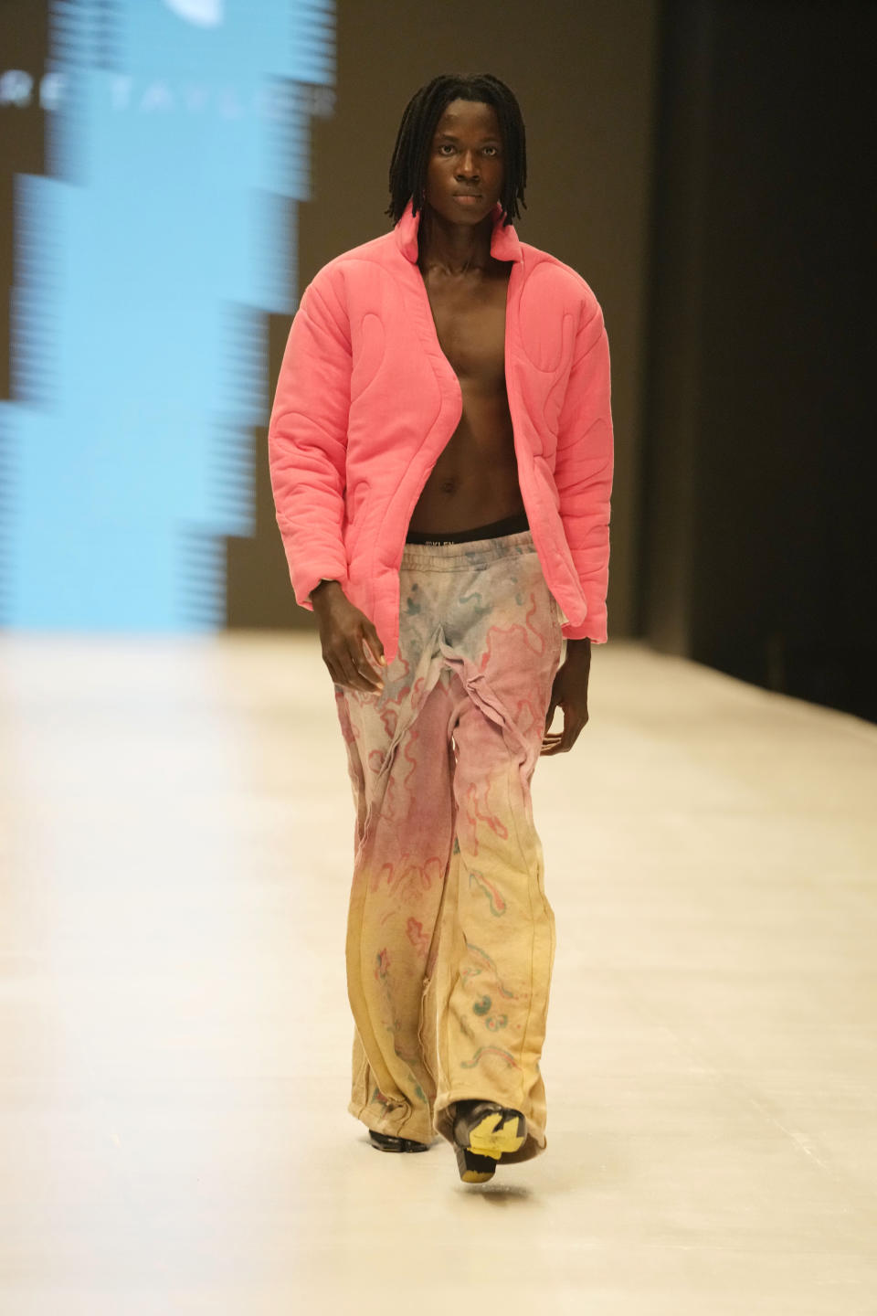 A model wears a creation by Pettre Tylor during the Lagos Fashion Week in Lagos, Nigeria, Thursday, Oct. 26, 2023. Africa's fashion industry is rapidly growing to meet local and international demands but a lack of adequate investment still limits its full potential, UNESCO said Thursday in its new report released at this year's Lagos Fashion Week show. (AP Photo/Sunday Alamba)