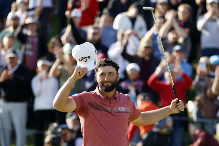 Jon Rahm celebrates on the 18th green after winning the Genesis Invitational golf tournament at Riviera Country Club, Sunday, Feb. 19, 2023, in the Pacific Palisades area of Los Angeles. (AP Photo/Ryan Kang)