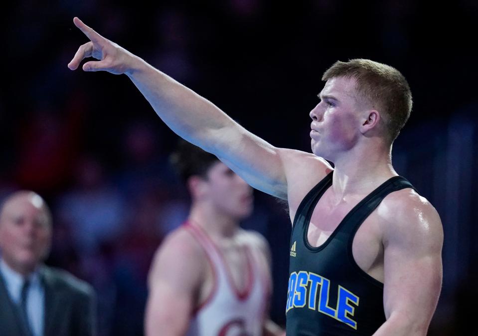 Castle John Purdy celebrates defeating Center Grove Kaden McConnell in the 195 weight-class finals during the IHSAA Wrestling State Finals Saturday, Feb.19, 2023 at Gainbridge Fieldhouse in Indianapolis. 