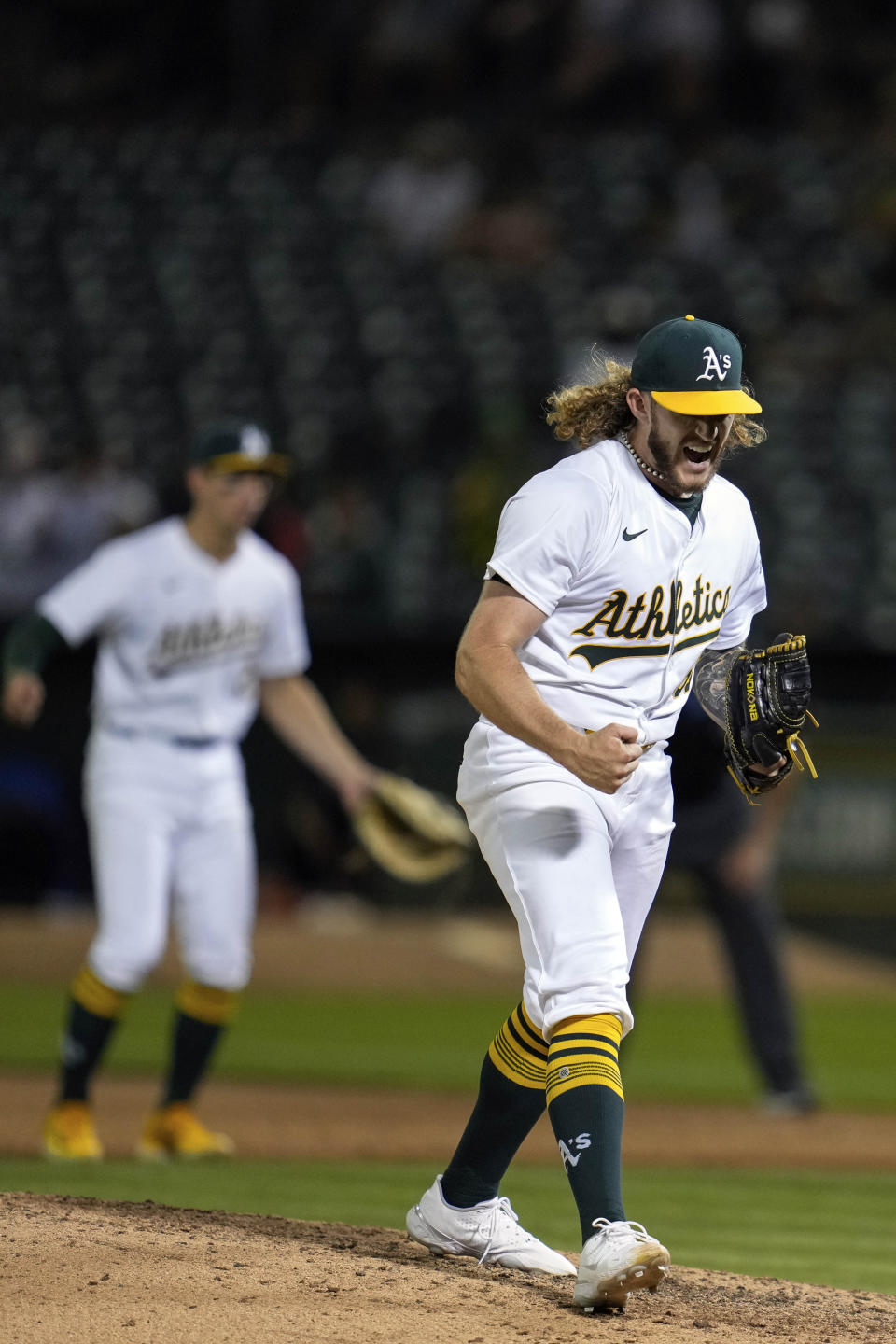 Oakland Athletics pitcher Joey Estes, right, reacts after striking out Los Angeles Angels' Taylor Ward to end a baseball game Wednesday, July 3, 2024, in Oakland, Calif. The Athletics won 5-0. (AP Photo/Godofredo A. Vásquez)