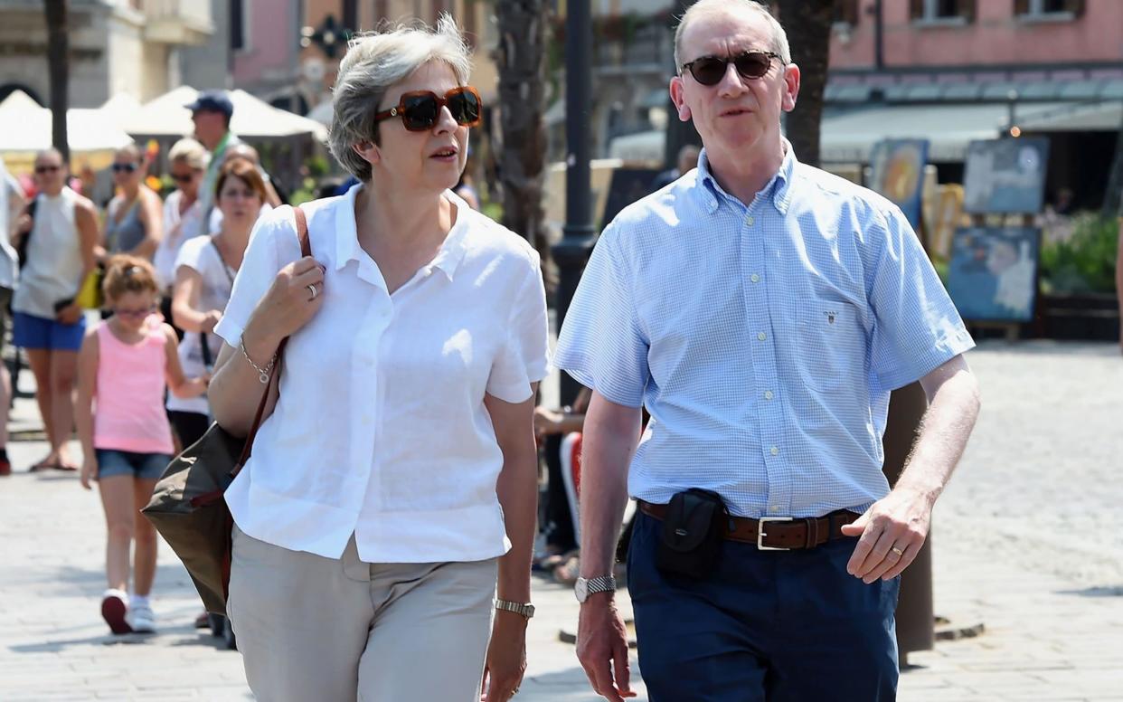 Mrs May is currently on holiday with her husband Philip - AFP