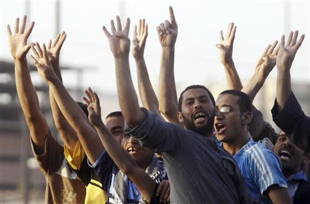 People show the "Rabaa" or "four" gesture, in reference to the police clearing of Rabaa al-Adawiya protest camp on August 14, during a traffic jam as members of the Muslim Brotherhood and supporters of ousted Egyptian President Mohamed Mursi stage a protest along a highway in the southern suburb of Maadi, September 3, 2013. REUTERS/Amr Abdallah Dalsh