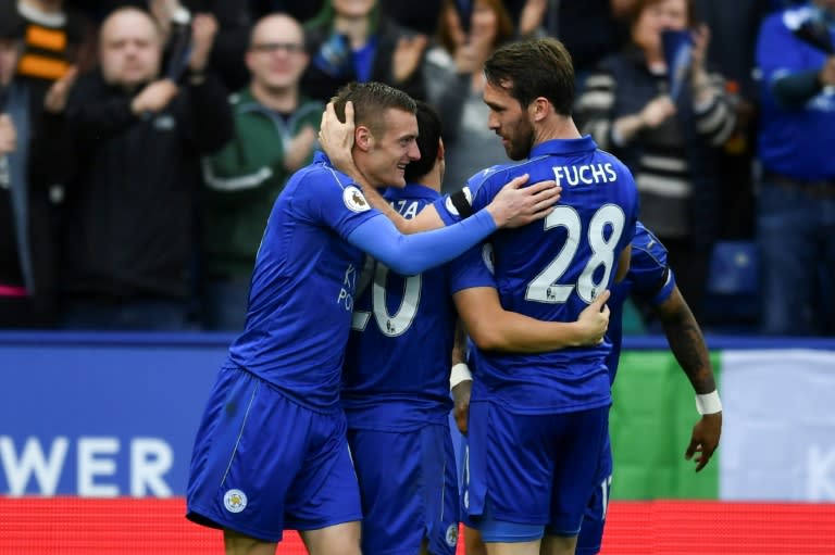 Leicester City's Jamie Vardy (L) is congratulated by teammate Christian Fuchs after scoring a goal during their English Premier League match against Stoke City, at King Power Stadium in Leicester, on April 1, 2017