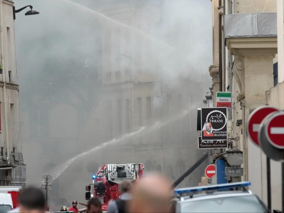 Firemen use a water canon to put out the blaze (AP)