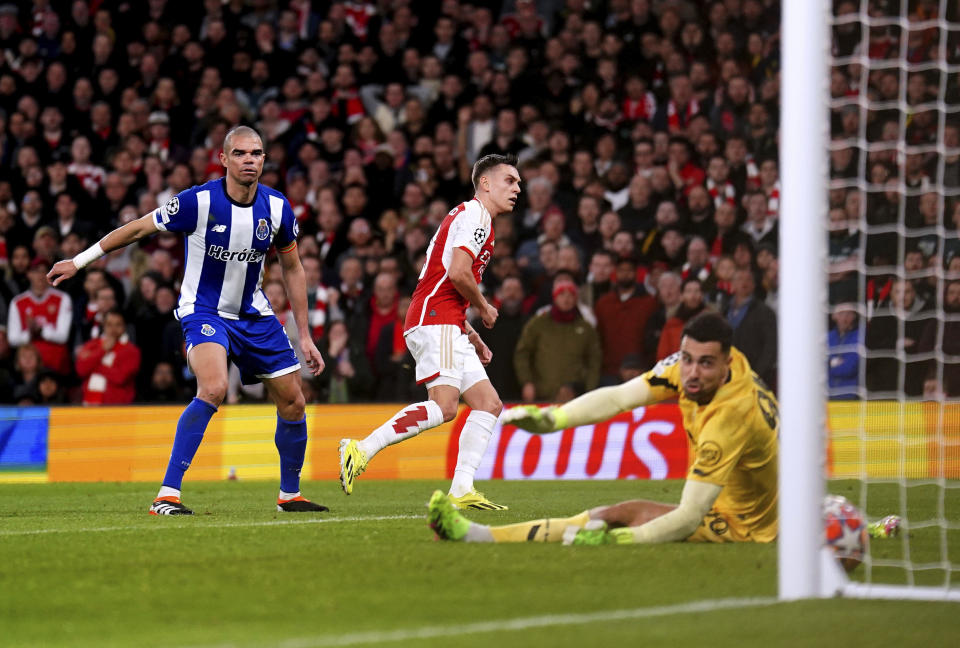 Arsenal's Leandro Trossard, center, scores during the Champions League round of 16, second leg soccer match between Arsenal and Porto at the Emirates Stadium, London, Tuesday March 12, 2024. (Zac Goodwin/PA via AP)
