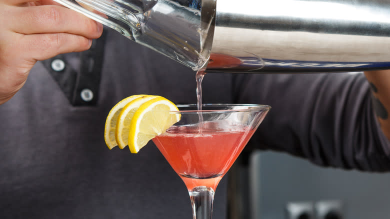 pouring alcohol into martini glass