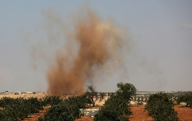 This picture taken on September 6, 2018 shows smoke plumes rising from Syrian regime bombardment on the town of Al-Tamanah on the southern edges of the rebel-held Idlib province