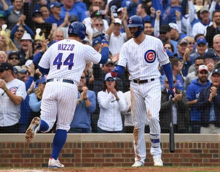 Oct 1, 2018; Chicago, IL, USA; Chicago Cubs first baseman Anthony Rizzo (44) celebrates with third baseman Kris Bryant (17) after hitting a solo home run during the fifth inning against the Milwaukee Brewers in the National League Central division tiebreaker game at Wrigley Field. Mandatory Credit: Patrick Gorski-USA TODAY Sports