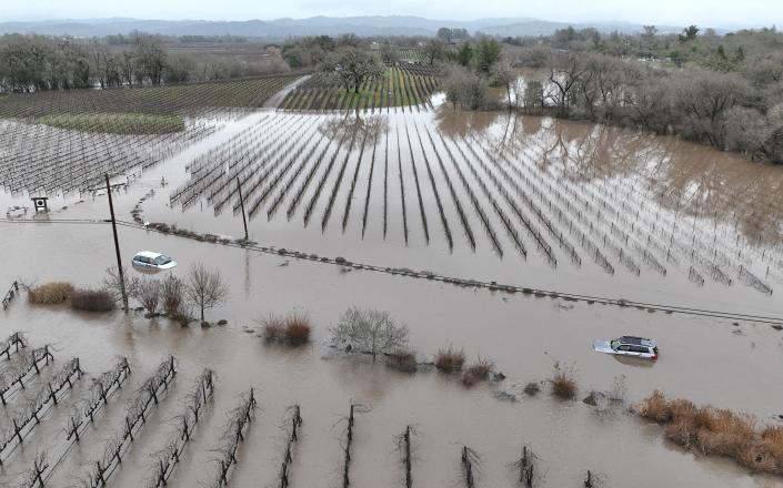 In an aerial view, cars are submerged in floodwater after heavy rain moved through the area on January 9, 2023 in Windsor, California. California continues to get drenched by powerful atmospheric river events that have brought high winds and flooding rains.