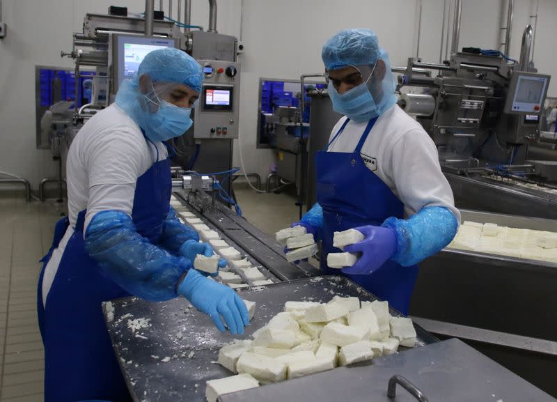 Workers sort halloumi cheese at the Petrou Bros Dairy in Aradippou