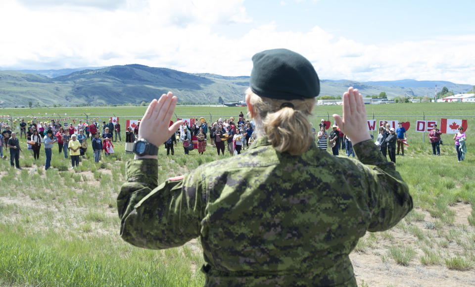 Royal Canadian Air Force Public Affairs Officer Lt. Alexandra Hejduk reacts to a First Nations drummers salute during a drum ceremony to remember fallen Snowbirds Capt. Jenn Casey in Kamloops, B.C., Monday, May 18, 2020. Capt.Casey died Sunday after the Snowbirds jet she was in crashed shortly after takeoff. The pilot of the aircraft is in hospital with serious injuries. (Jonathan Hayward/The Canadian Press via AP)