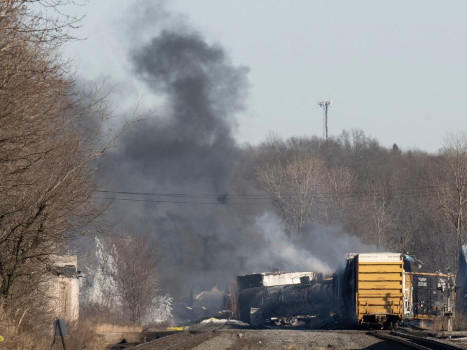 Smoke rises from the derailed train on February 4.