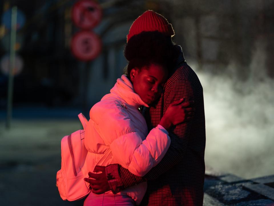 A couple hugging on a dark street
