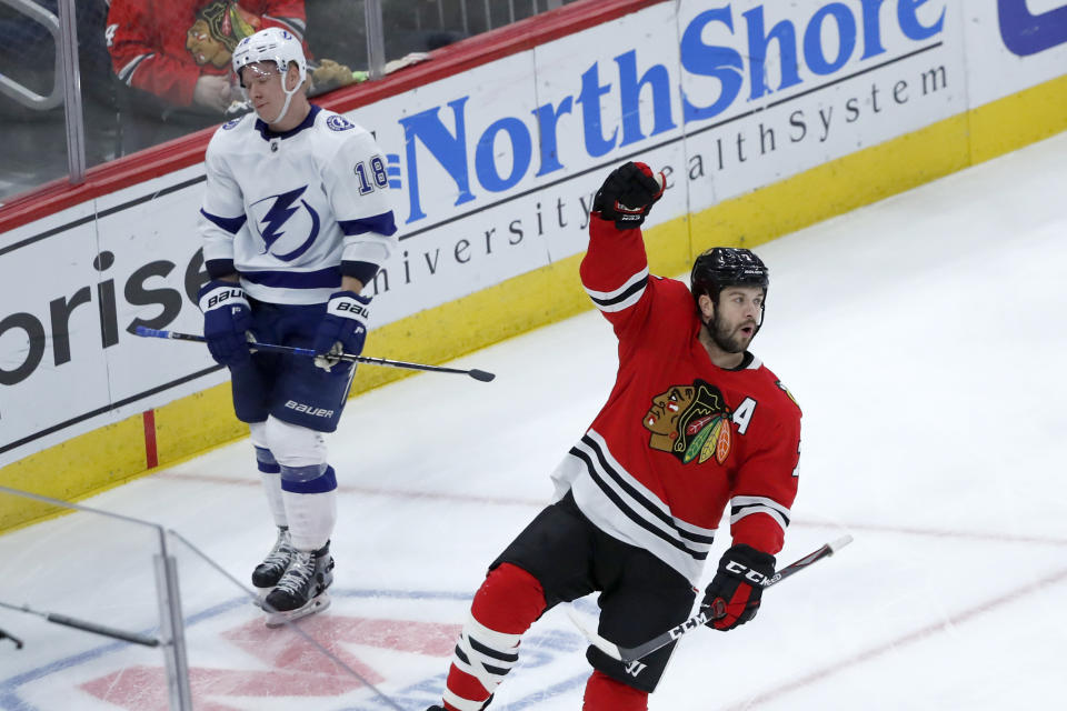Chicago Blackhawks' Brent Seabrook, right, celebrates his goal as Tampa Bay Lightning's Ondrej Palat skates by during the third period of an NHL hockey game Thursday, Nov. 21, 2019, in Chicago. Tampa Bay won 4-2. (AP Photo/Charles Rex Arbogast)