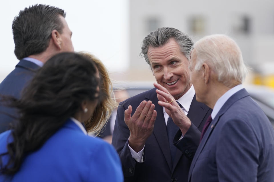 President Joe Biden talks with California Gov. Gavin Newsom and his wife Jennifer, San Francisco Mayor London Breed and Rep. Kevin Mullin, D-Calif., as he arrives at San Francisco International Airport for the APEC summit, Tuesday, Nov. 14, 2023, in San Francisco. (AP Photo/Evan Vucci)