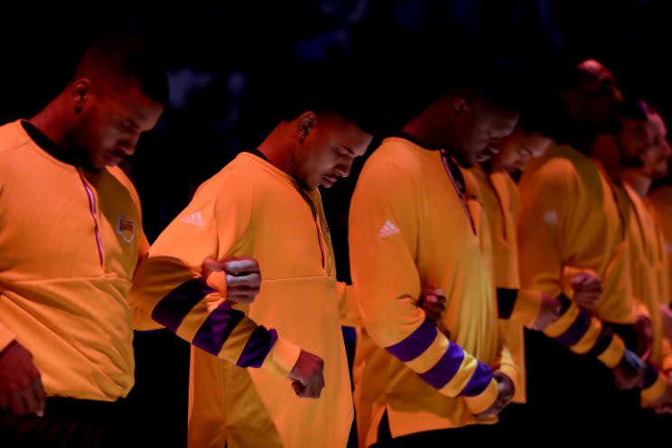 The Lakers were one of many NBA teams to lock arms in a show of unity during the national anthem early this season. (AP)